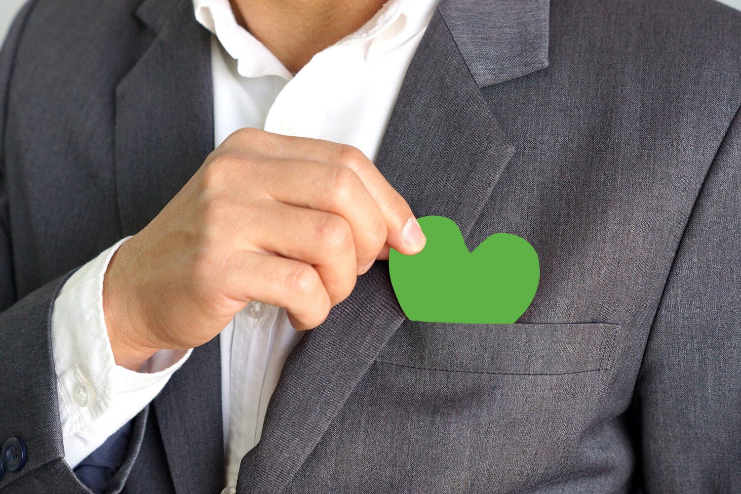 Businessman holding a green heart